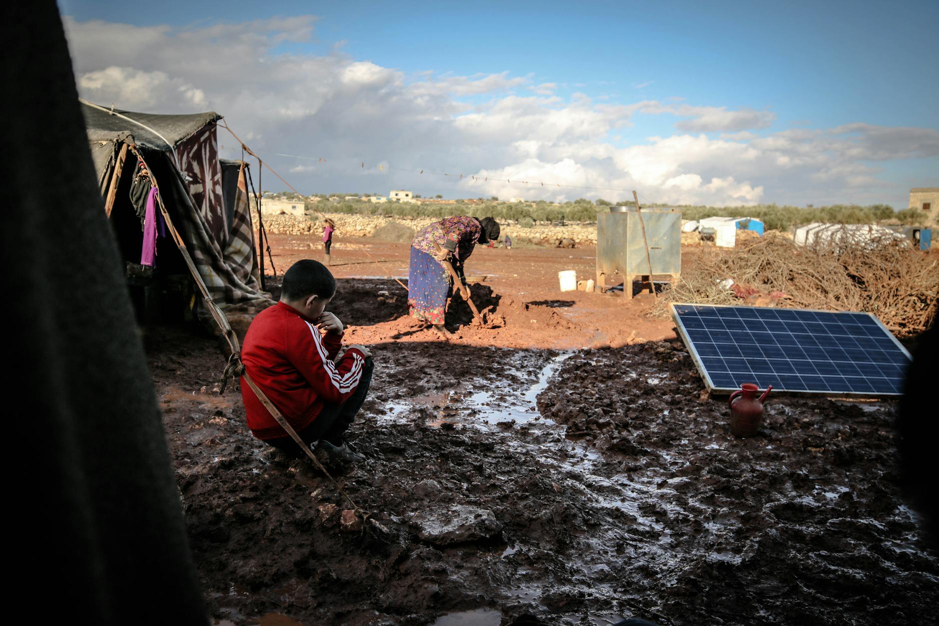elderly woman working in mud